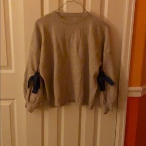Tan Sweater With Blue Bows in the Sleeves